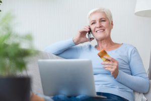 mature lady shopping online with credit card and l 3TY5GA3